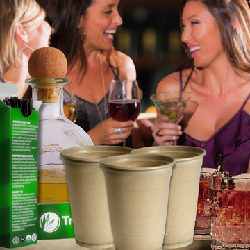 3 women enjoying drinks behind a setup featuring agave cups, along with tequila and mixed drinks.