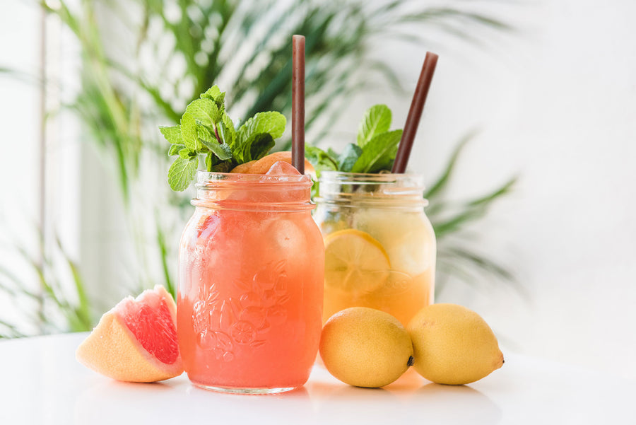 Product feature for agave straws. Two cups of fruit drinks with agave straws in both of them.